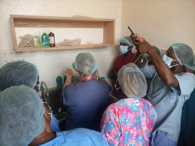 Nurse Fellow Kristen Urbanek teaching Operating Room clinical staff handwashing techniques in Harper, Liberia (March 2025)
