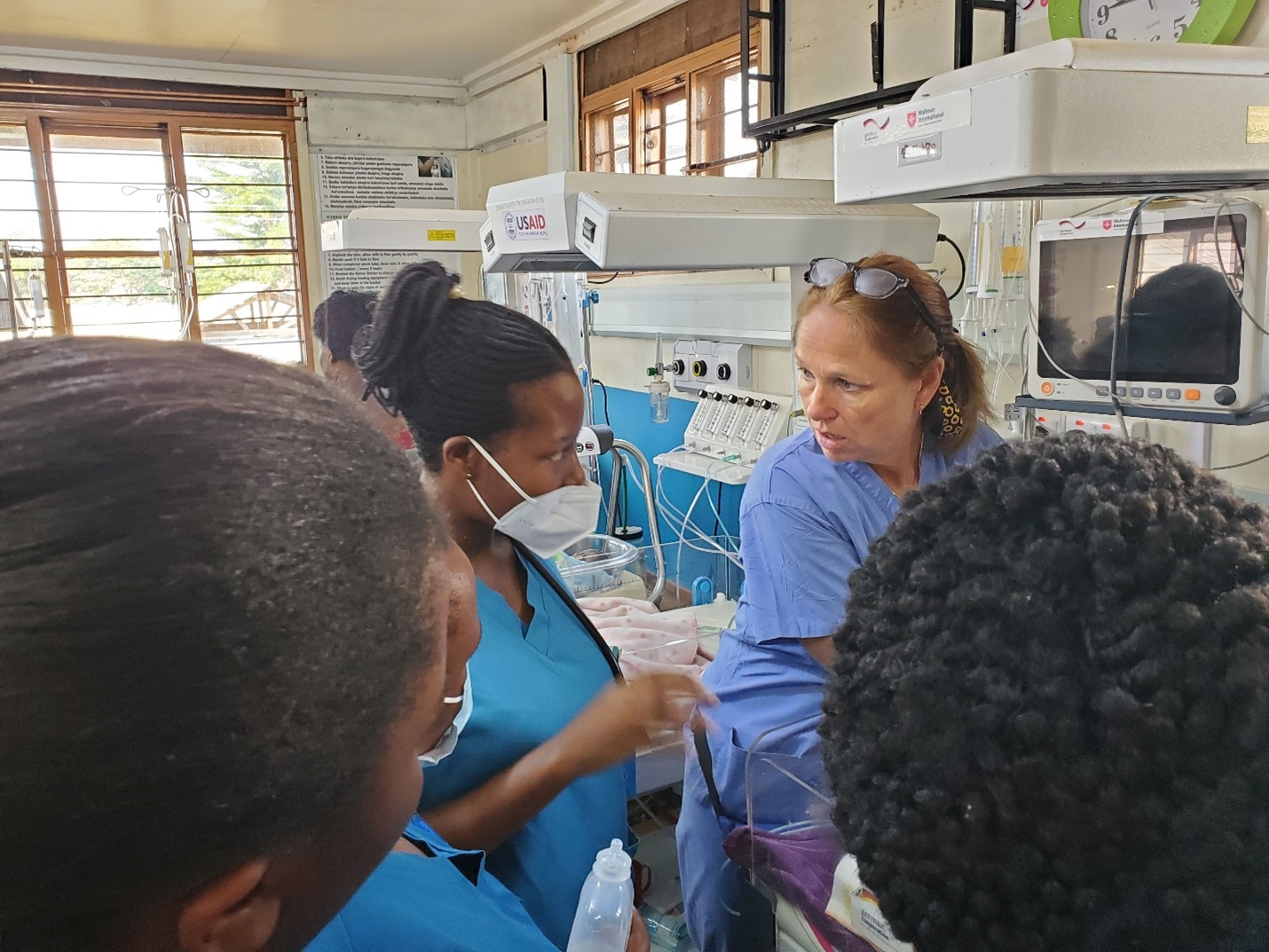 Nurse Fellow Jennifer Samiotes working with Master of Pediatric Critical Care Nursing students in the Neonatal Intensive Care Unit at Mbarara Regional Referral Hospital, July 2024.