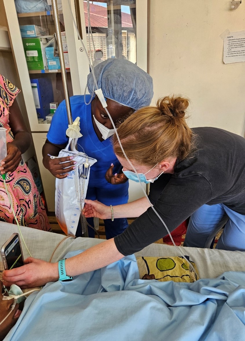 Carolyn McDonald instructing Beatrice Katusiime, Nurse Leader of the Neurological High Dependency Unit at Mbarara Regional Referral Hospital on accurately measuring intracranial pressure using an external ventricular drain using a cell phone application (2024).